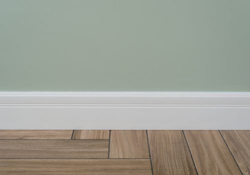 Light green matte wall, white baseboard